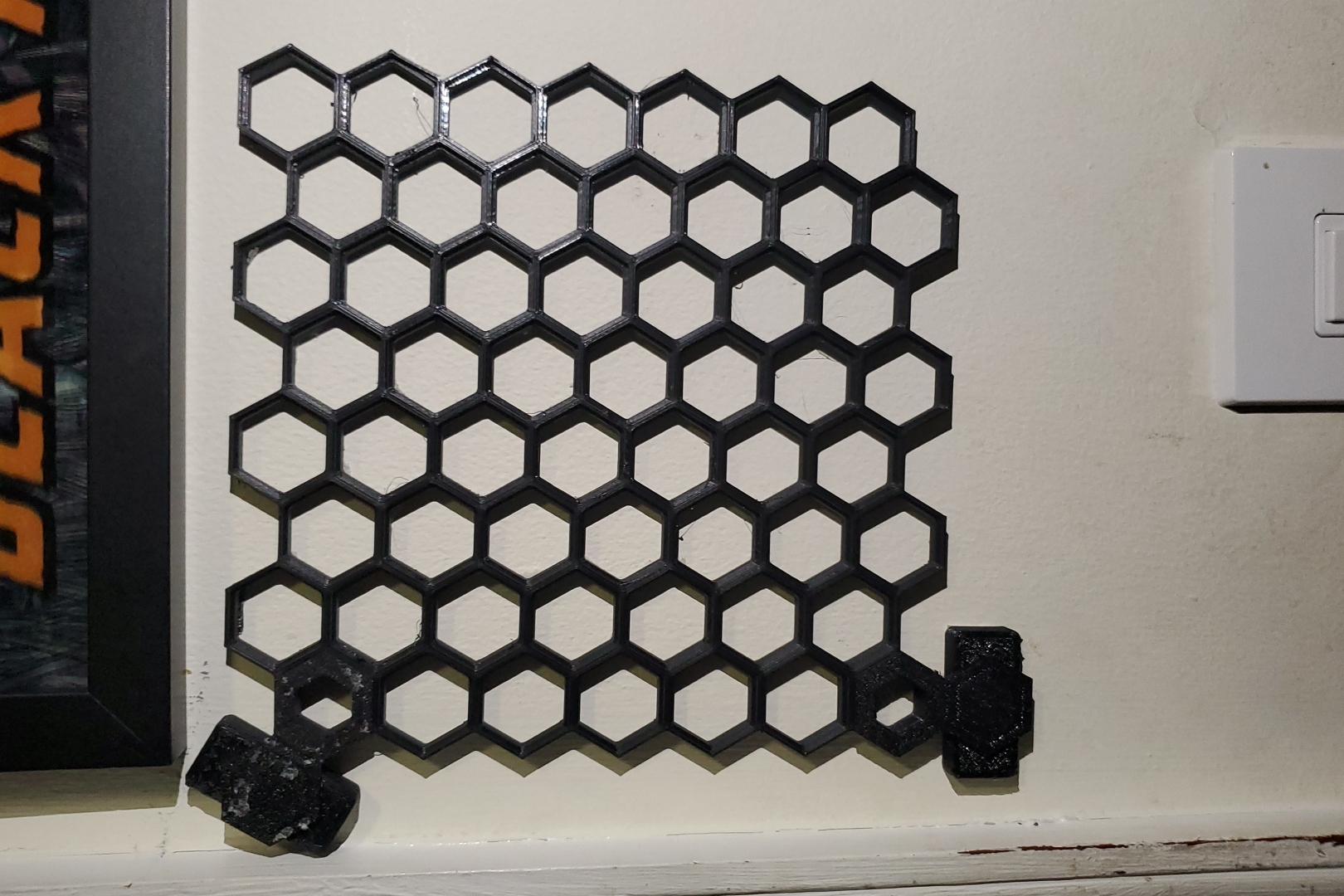Command strip hanger for Honeycomb storage wall (now print in place)