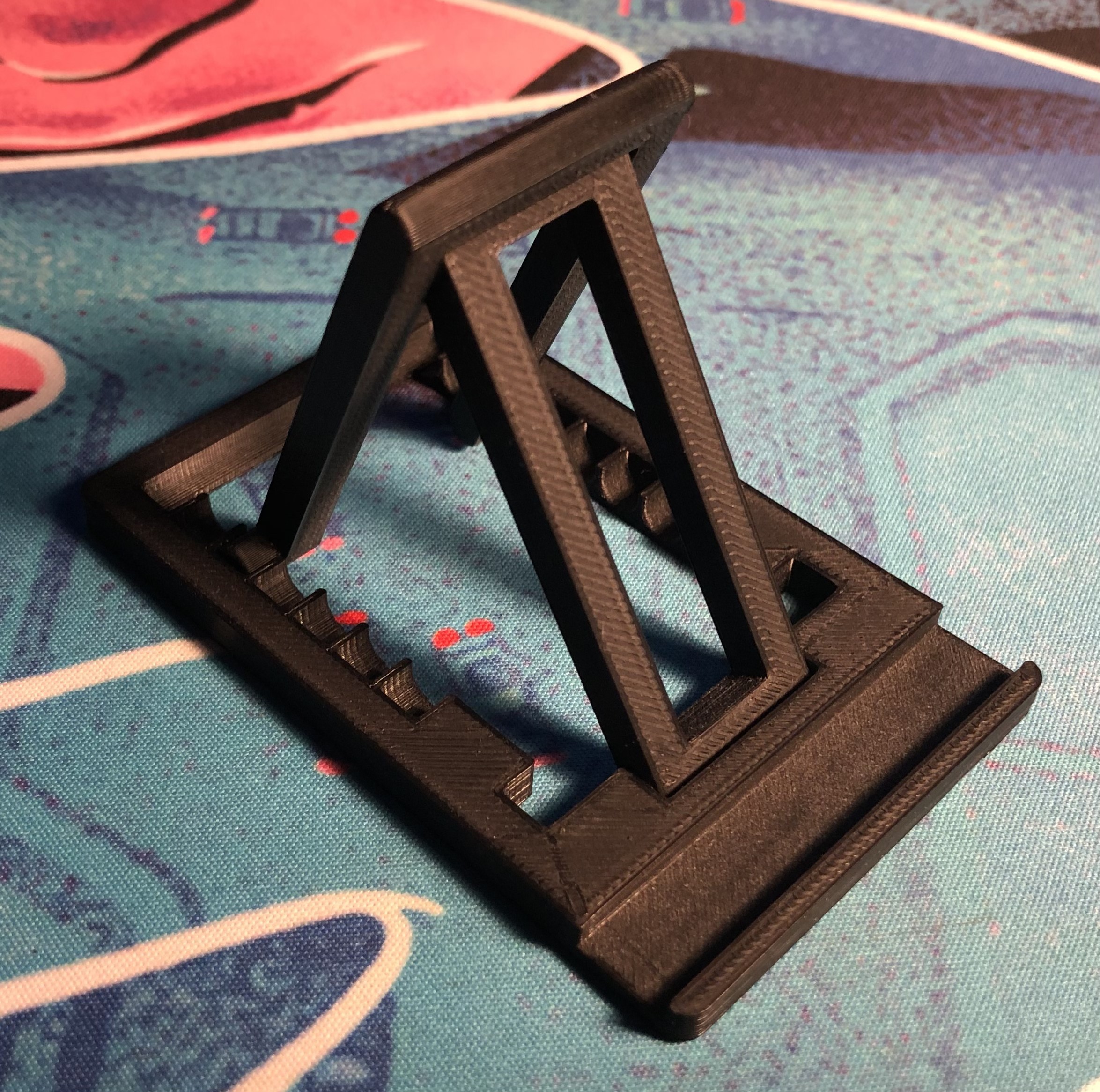 Universal phone/tablet stand with adjustable angle.