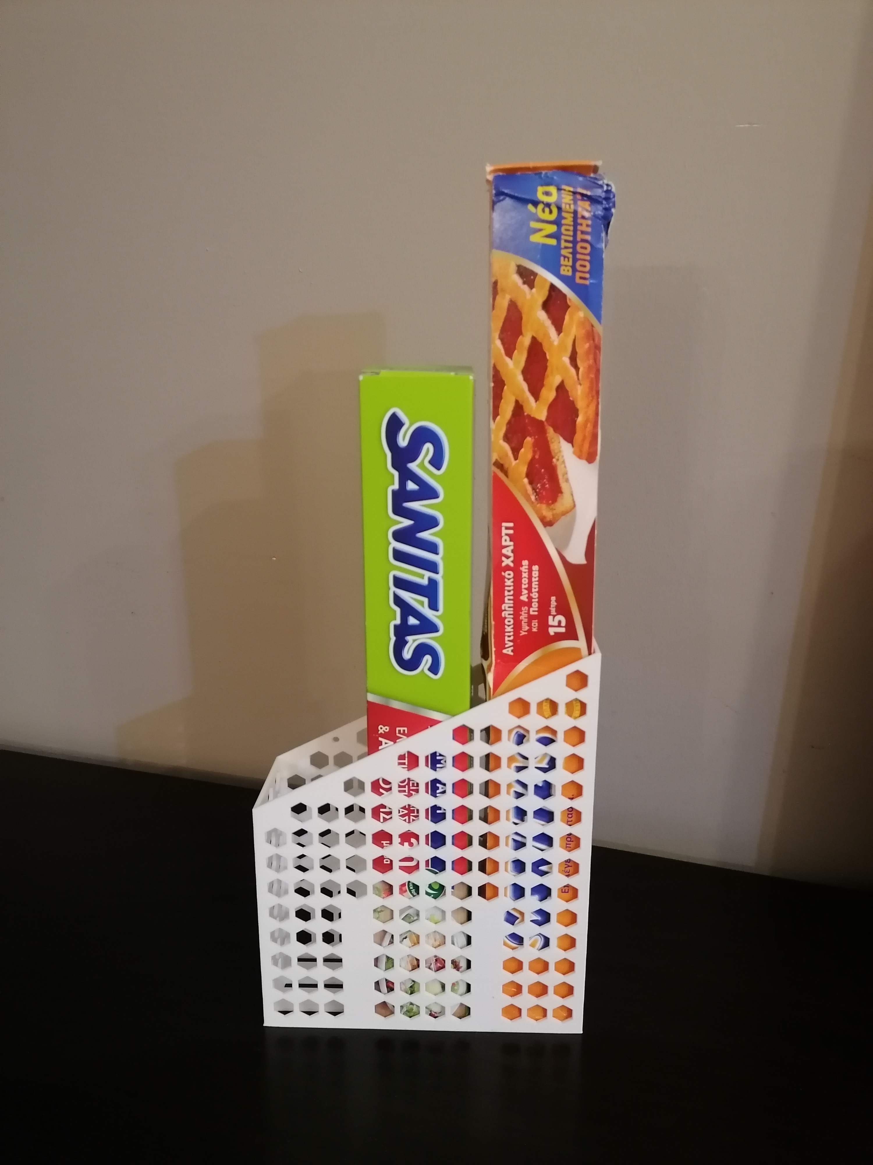 Kitchen storage box for aluminum foil, plastic wrap and baking paper.